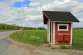 Landscape of Red Wooden Bus Stop Shelter with Two Mail Boxes Royalty Free Stock Photo