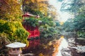 Landscape with Red wooden house in japanese style garden, park with pond and autumn trees. Traditional japan architecture. Royalty Free Stock Photo