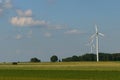 Landscape from renewable energy wind turbine with field, forest and sky Royalty Free Stock Photo