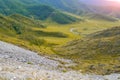 Landscape of the ridge covered with green trees and stones and v