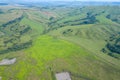 Landscape of the ridge covered with green trees and view a valley flooded with sunlight ,pasture, summer day in the mountains of Royalty Free Stock Photo