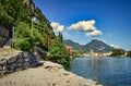 landscape of Riva del Garda, Italy- garda lake with mountains, peaks, town, palm, beach, blue sky Royalty Free Stock Photo