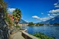 landscape of Riva del Garda, Italy- garda lake with mountains, peaks, town, palm, beach, path, wall Royalty Free Stock Photo