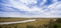 Landscape river in a bright summer field on a cloudy day Royalty Free Stock Photo