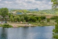 Landscape of river and camping site under cloudy sky