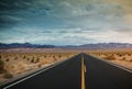 landscape with a road crossing the desert of death valley in California with the mountains in the background Royalty Free Stock Photo