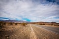 landscape with a road crossing the desert of death valley in California with the mountains in the background Royalty Free Stock Photo