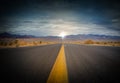 landscape with a road crossing the desert of death valley in California with the mountains in the background Royalty Free Stock Photo