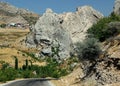 A landscape with a road, a rock and the ruins of the old castle of Kahta in Turkey