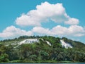 landscape with rock, shrub, large cloud. rock consists of Cretaceous