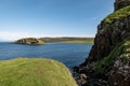 The landscape with a rock where the Duntulm Castle stands and an island at Isle of Skye, Scotland