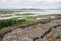 Landscape with rocks, Oxara river and large Thingvallavatn lake in Thingvellir, Iceland in overcast weather