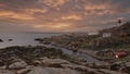 Landscape rocky coast of the northern sea, traditional wooden red Norwegian houses and the southern lighthouse Lindesnes fyr Norwa Royalty Free Stock Photo