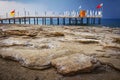 Landscape of rocky turkish beach on blue sea with pier, Konakli Turkey. seascape of stone beach in the morning. Royalty Free Stock Photo