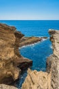 Rugged volcanic rocks of cliff at Vila Franca do Campo islet with blue sea, SÃ£o Miguel - Azores PORTUGAL Royalty Free Stock Photo