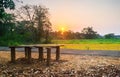 Landscape of a rustic manmade bench for relaxing with sunset in the background, Tranquil environment image of bench with no person Royalty Free Stock Photo