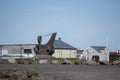 Landscape of rusty anchor statue and building in Keflavik Iceland Royalty Free Stock Photo