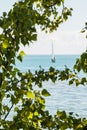 Landscape with sailboat seen from the coast