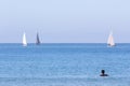 Landscape with sailboats and a man in the water