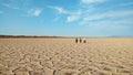 People walking on polygons of salt flat , Iran