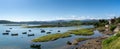 Landscape of the San Vicente de la Barquera river delta and Picos de Europa in Cantabria with colorful wooden rowboats