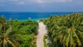 Landscape with sandy road leading to the beach at the island Manadhoo the capital of Noonu atoll Royalty Free Stock Photo
