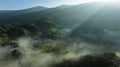 Landscape sapan village in the valley and the sea of mist in the morning with sun rays and mountain shadow layays, in winter