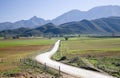 Gravel road leading into farmland Royalty Free Stock Photo