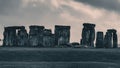 Landscape scene of Stonehenge monument in England under dramatic cloudy sky