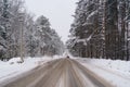 Landscape scenery photo of dirty road going up along beautiful snow-covered coniferous forest Royalty Free Stock Photo