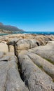 Landscape, scenic and copyspace view of rocks and boulders on the seaside or coast against a clear blue sky in summer
