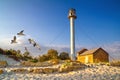 Landscape with sea lighthouse on the coast during sunrise near the ruins Royalty Free Stock Photo