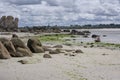 Landscape at the sea a summer beach with rocks and two children, small idyllic city in the background, summer holidays Royalty Free Stock Photo