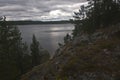 landscape sea water forest rocks rocks sky clouds pines wildlife north