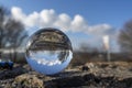 landscape seen through a gals ball. In the background the steam from a cooling tower