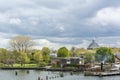 Landscape with several dutch houses and river under the cloudy sky Royalty Free Stock Photo