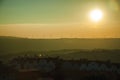 Landscape and several wind turbines silhouettes on sunset