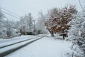 Residential neighborhood city street in severe snowstorm slant view Royalty Free Stock Photo