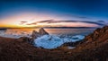 Landscape of Shamanka rock at sunset with natural breaking ice in frozen water on Lake Baikal, Siberia, Russia Royalty Free Stock Photo