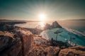 Landscape of Shamanka rock at sunset with natural breaking ice in frozen water on Lake Baikal, Siberia, Russia Royalty Free Stock Photo