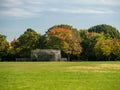 Landscape shot of a beautiful park with chain link backstop under the lush trees