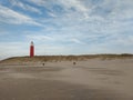 Landscape shot of the coast and the red Texel Lighthouse in De Cocksdorp, Netherlands Royalty Free Stock Photo