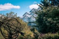 Landscape shot of the greenhouse and statue in the gardens