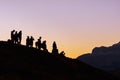 Landscape shot of a mountain peak with hikers in silhouette. Perfect for a hiking blog