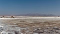 Landscape shot of the process of loading salt onto a truck at Maharlu lake in Shiraz, Iran