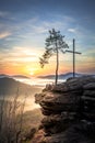 Four castles view, RÃÂ¶tzenfels, a sandstone rock with a cross and a tree. Sunrise, fog, Palatinate Forest, Germany. landscape shot Royalty Free Stock Photo