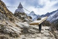 Landscape showing sherpa carrying heavy wooden doors hiking up the himalayan mountains towards the everest base camp, Nepal Royalty Free Stock Photo