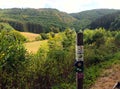 Landscape with sign of hiking-trail in region Eifel Ardennes, border between Luxembourg and Germany