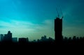 The landscape of silhouette of high rise building with the crane on top at sunrise in downtown of Bangkok, Thailand, blue and Royalty Free Stock Photo