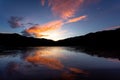 landscape silhouette The mountains, the sunset in the evening sky, and then the light hits the clouds is orange. There is a Royalty Free Stock Photo